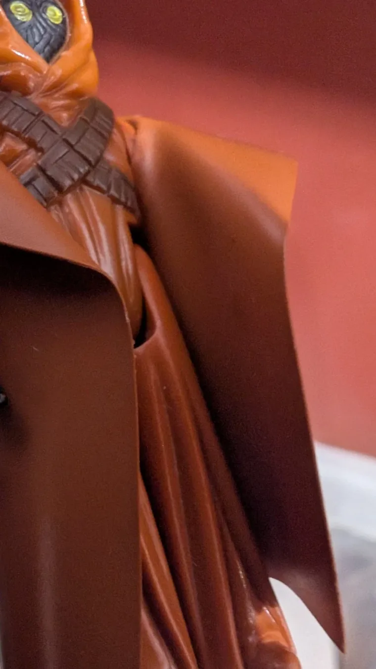 Close detail of the Jawa's eyes, bandolier and vinyl cape
