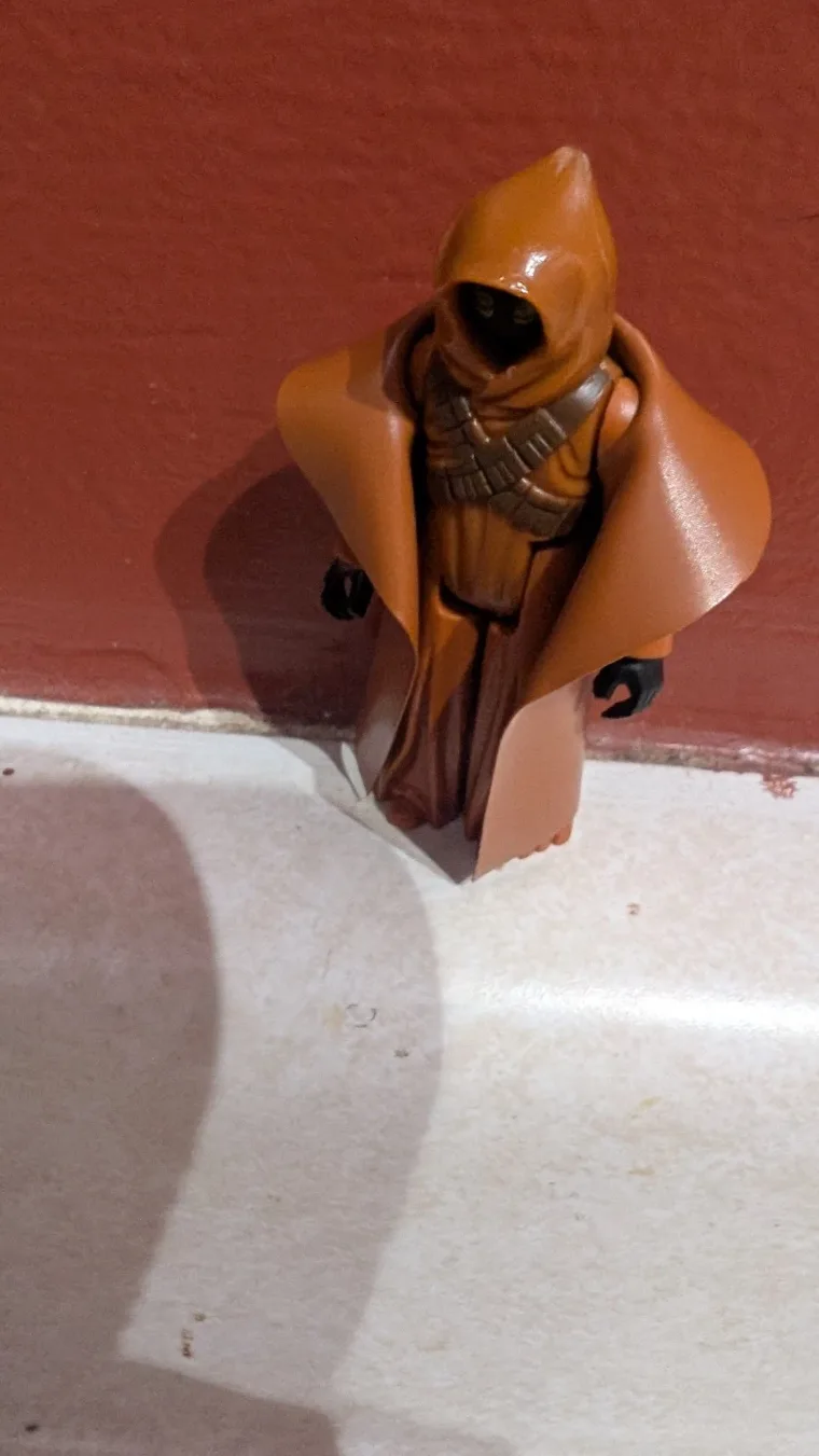 Vinyl-cape Jawa from a raised camera, cape spread to the sides