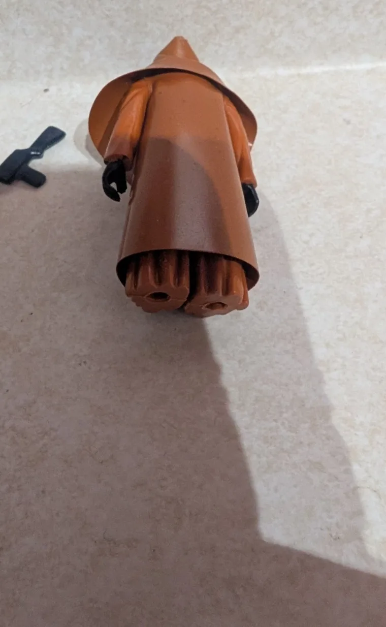 Vinyl-cape Jawa lying face down from above, feet and legs visible